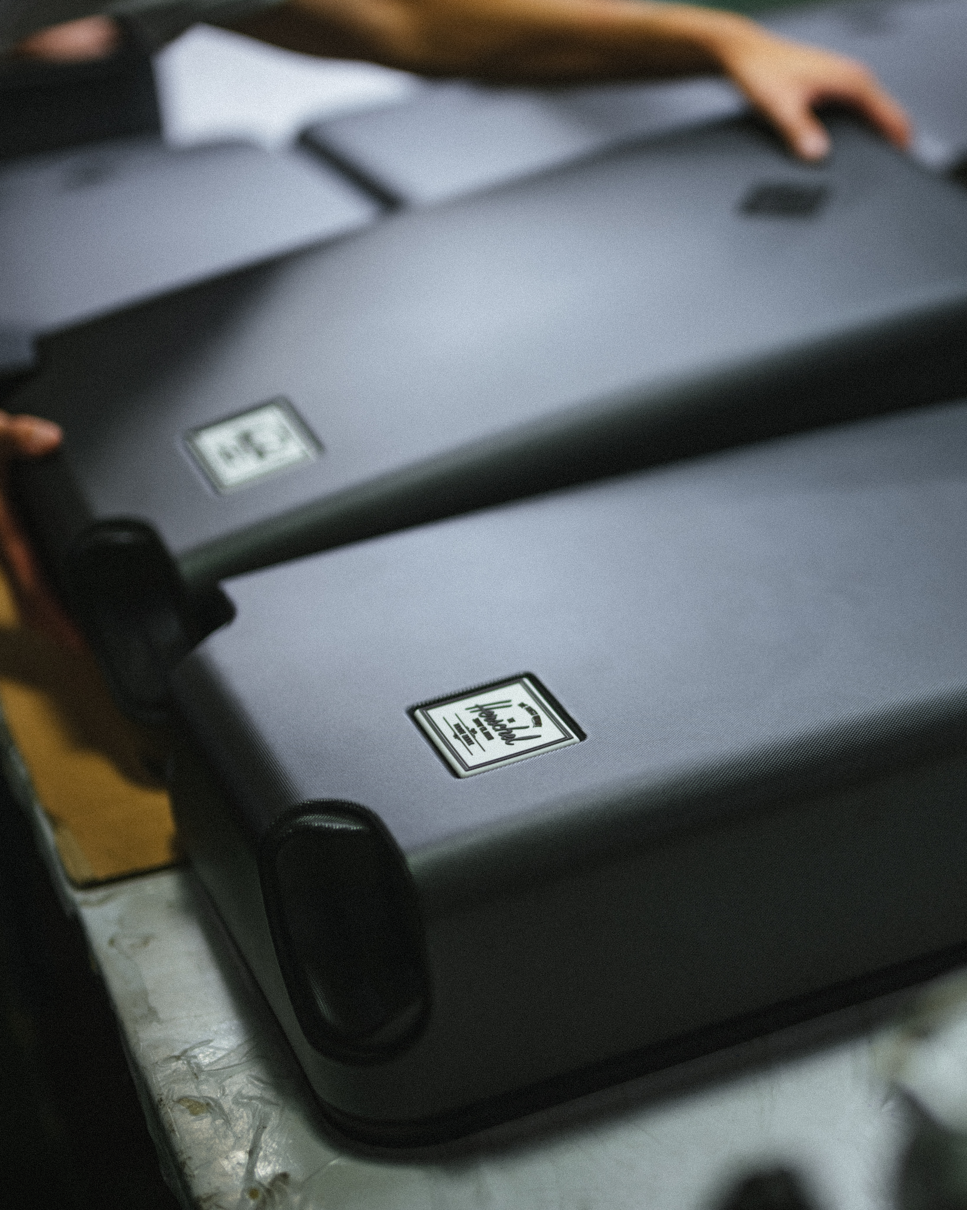 Herschel Heritage Hardshell Medium Luggage features showing four inset Hinomoto wheels that spin 360 degrees and roll silently.