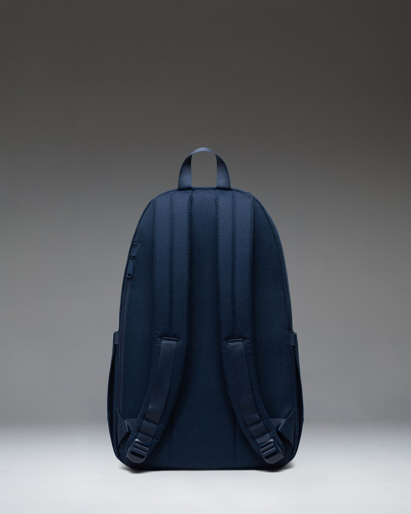 Herschel Seymour Backpack in Navy showing a detailed view of its streamlined design, adjustable shoulder straps, and signature diamond detail.