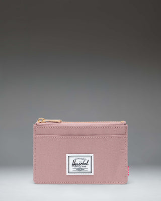 Herschel Supply Co. Oscar Cardholder wallet in Ash Rose pink showing a front view with card slots and a main zip compartment.