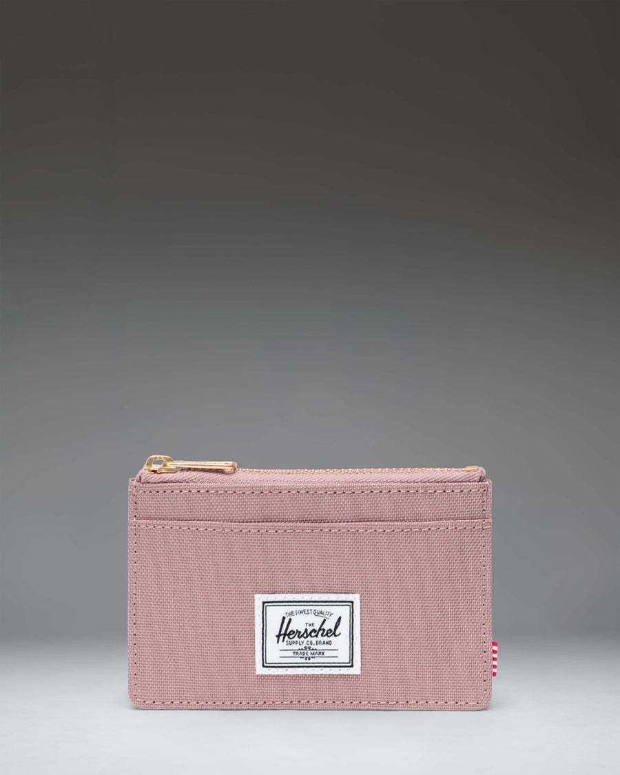 Herschel Supply Co. Oscar Cardholder wallet in Ash Rose pink showing a front view with card slots and a main zip compartment.