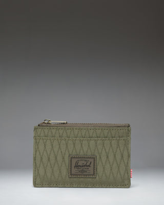 Herschel Supply Co. Oscar Cardholder in Ivy Green Diamond featuring a slim design with card slots and a zipped main compartment.