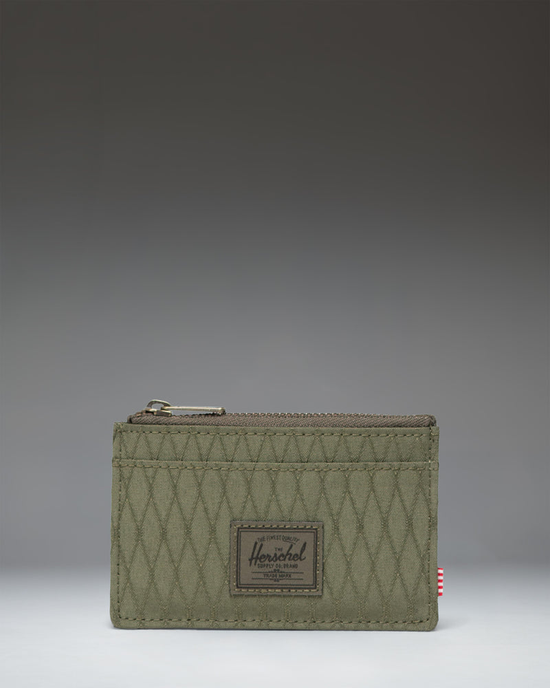 Herschel Supply Co. Oscar Cardholder in Ivy Green Diamond featuring a slim design with card slots and a zipped main compartment.