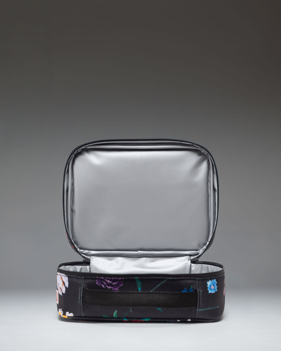 Herschel Supply Co. LEGO Pop Quiz Lunch Box in Falling Florals floral print, showing the insulated main compartment and front pocket.