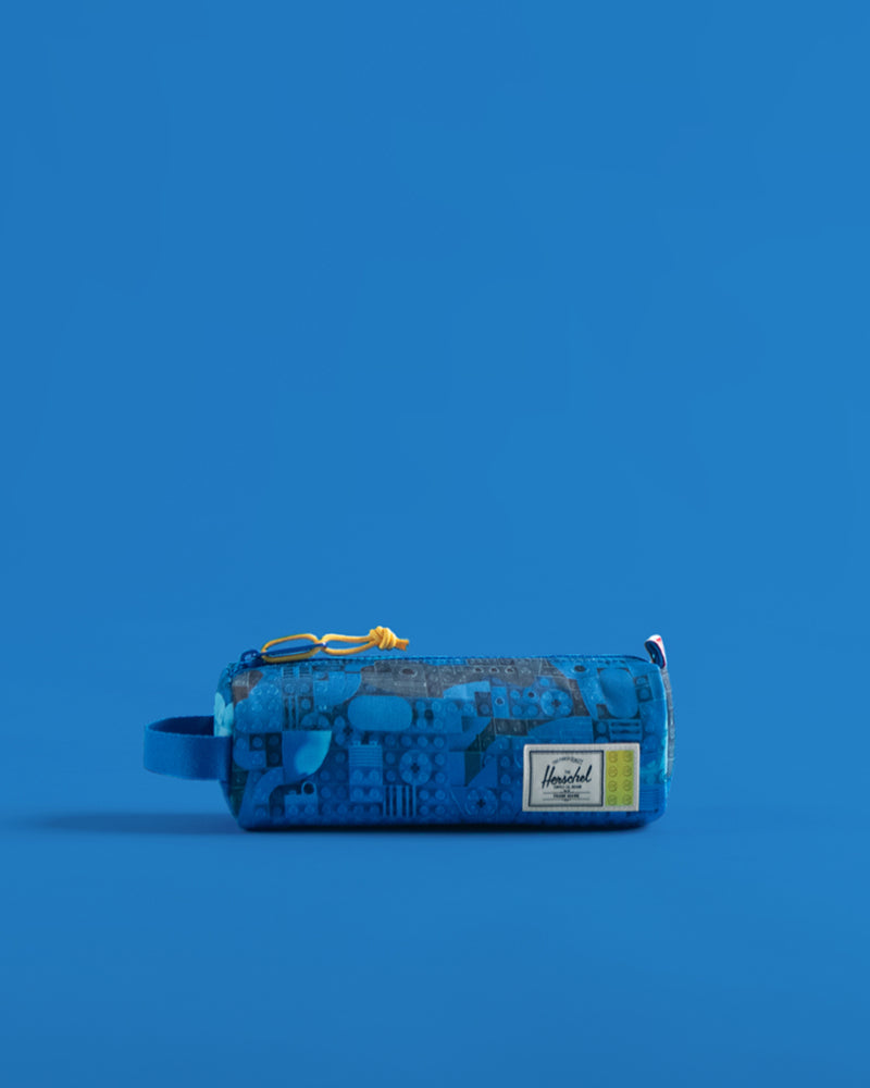 Herschel Supply Co. LEGO Settlement Pencil Case Little Herschel in Abstract Bricks Blue featuring a colorful LEGO brick pattern.