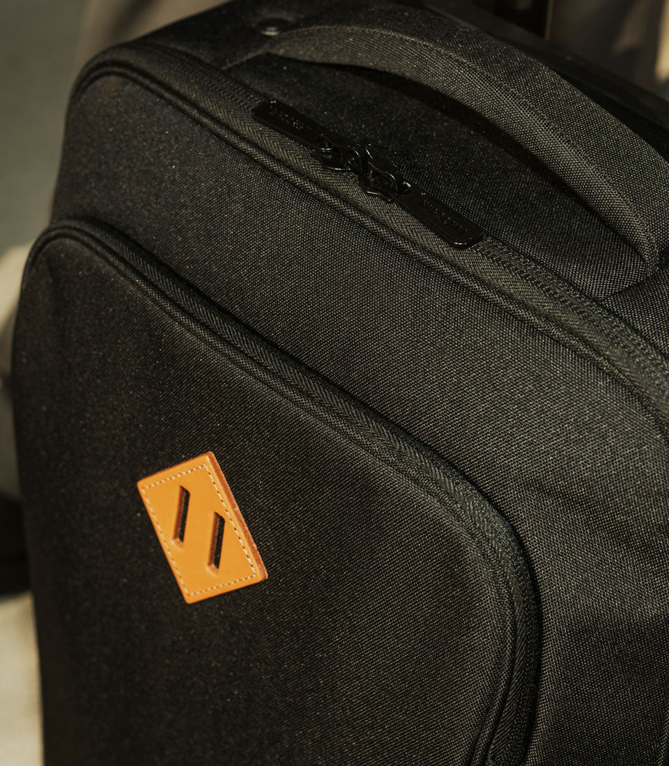 Herschel Heritage Softshell Medium Luggage being pulled on its two all-terrain wheels by a traveler.