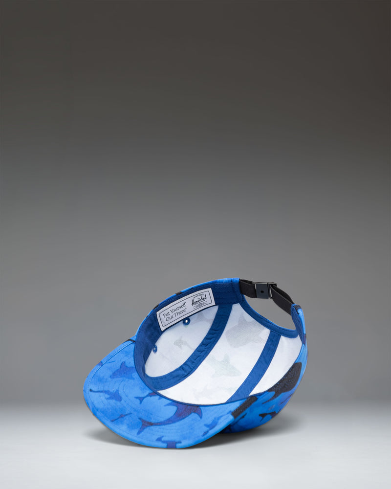 Herschel Supply Co. Glendale Kids Cap in Sharks print, featuring a blue background with various shark illustrations.