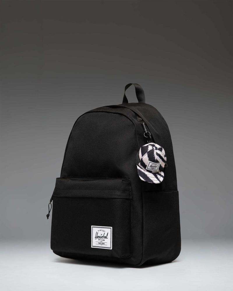 Miniature Herschel Supply Co. Sylas Classic Cap Bag Charm in a black and white zebra stripe print.